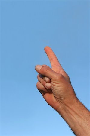 simsearch:400-05700994,k - Hand of a man ponting his forefinger towards a blue sky. Focus on the forefinger. Stock Photo - Budget Royalty-Free & Subscription, Code: 400-04438031