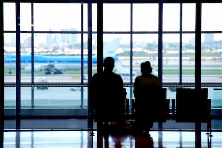 plane delay - Couple waiting at the international airport terminal Stock Photo - Budget Royalty-Free & Subscription, Code: 400-04438078