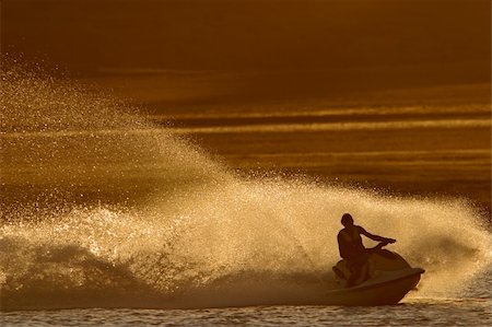 Backlit jet ski with water spray, late afternoon Stock Photo - Budget Royalty-Free & Subscription, Code: 400-04438149