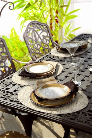 simsearch:400-04064749,k - Table setting on a patio table with plates and martini glasses Stock Photo - Budget Royalty-Free & Subscription, Code: 400-04438589