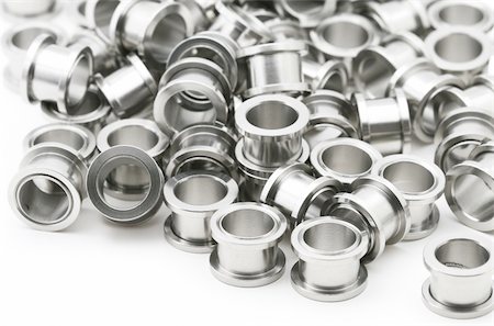 A big pile of screw on flesh tunnels. These are used in stretched ear lobes. Stockbilder - Microstock & Abonnement, Bildnummer: 400-04438772
