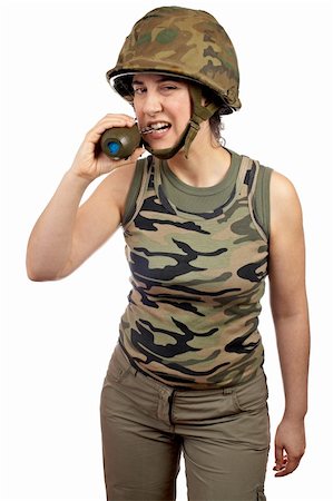 A beautiful soldier girl holding a hand grenade on white background Stock Photo - Budget Royalty-Free & Subscription, Code: 400-04439252