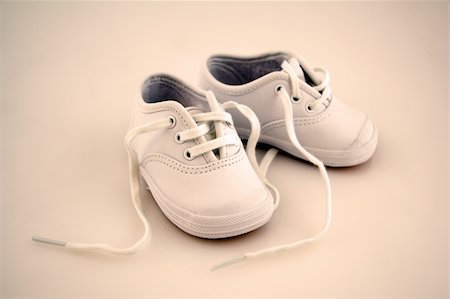 simsearch:400-04939110,k - Little Baby Shoes Isolated on a Background Photographie de stock - Aubaine LD & Abonnement, Code: 400-04430079