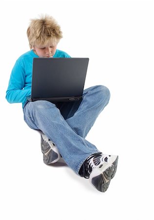 blonde boy working with laptop; isolated on white Photographie de stock - Aubaine LD & Abonnement, Code: 400-04430598