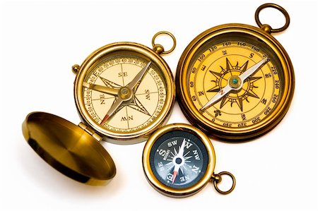 simsearch:400-07714543,k - Three old style brass compasses on white background Fotografie stock - Microstock e Abbonamento, Codice: 400-04430978