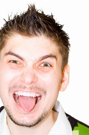 Young man with tongue out isolated on white background Stock Photo - Budget Royalty-Free & Subscription, Code: 400-04431511