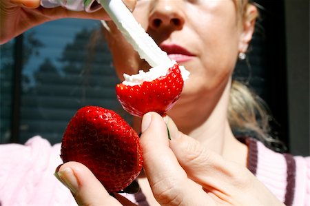 raspberry fingers - close up strawberries with cream in the fingers Stock Photo - Budget Royalty-Free & Subscription, Code: 400-04431694