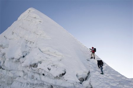 simsearch:400-08072890,k - Two climbers about to summit Island Peak in Nepal. The peak is very close to Everest and Lhotse. This picture was taken in in the middle of October at 6:45am. Foto de stock - Super Valor sin royalties y Suscripción, Código: 400-04431768