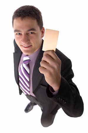 simsearch:400-06557209,k - Headshot of young man with golden credit card; White background; In studio. Focus on the card. Face unfocus. Photographie de stock - Aubaine LD & Abonnement, Code: 400-04431837