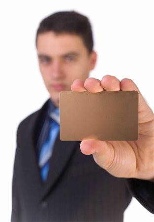 simsearch:695-03386967,k - Young man showing gold card; White background in studio. Focus on the card. Body unfocus. Stock Photo - Budget Royalty-Free & Subscription, Code: 400-04431839