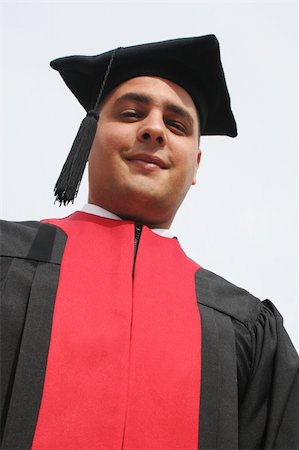 simsearch:400-04641615,k - Attractive young man in gowns to on university graduation day Foto de stock - Royalty-Free Super Valor e Assinatura, Número: 400-04431859