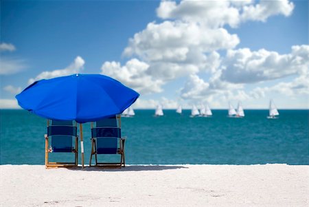 Empty  chairs on a white sand beach with a cloud filled sky Stock Photo - Budget Royalty-Free & Subscription, Code: 400-04432049