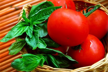 Fresh tomatoes and green basil in a basket Stock Photo - Budget Royalty-Free & Subscription, Code: 400-04432066