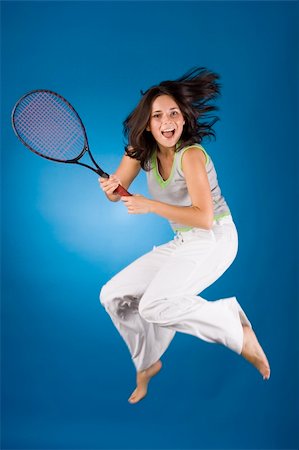 happy woman with tennis racket on the blue background Stock Photo - Budget Royalty-Free & Subscription, Code: 400-04432125