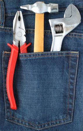 simsearch:400-07167932,k - Toolkit of hammer, adjustable spanner and combination pliers in a blue jeans pocket Foto de stock - Super Valor sin royalties y Suscripción, Código: 400-04432148