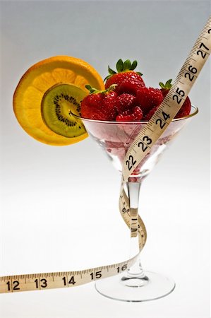 simsearch:400-05079848,k - Fresh strawberries, raspberries, orange, and kiwi in a wine glass with a tape measure wrapped around it - a delicious and nutritious snack. Foto de stock - Super Valor sin royalties y Suscripción, Código: 400-04432372