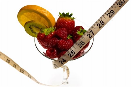 simsearch:400-05079848,k - Fresh strawberries, raspberries, orange, and kiwi in a wine glass with a tape measure wrapped around it - a delicious and nutritious snack. Foto de stock - Super Valor sin royalties y Suscripción, Código: 400-04432373