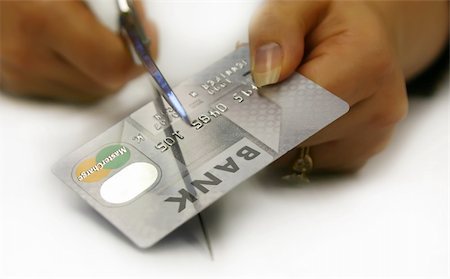 A female cutting up her credit card. The logo has been changed from Master Card to Master Charge. Stock Photo - Budget Royalty-Free & Subscription, Code: 400-04432436