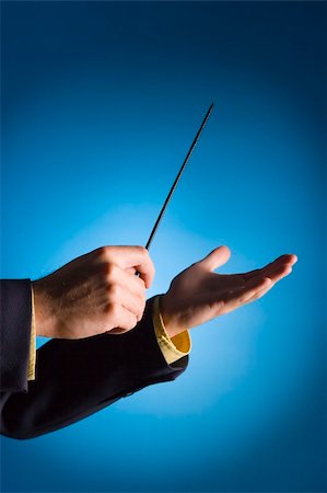 conductor's hands on blue background Stock Photo - Budget Royalty-Free & Subscription, Code: 400-04432751