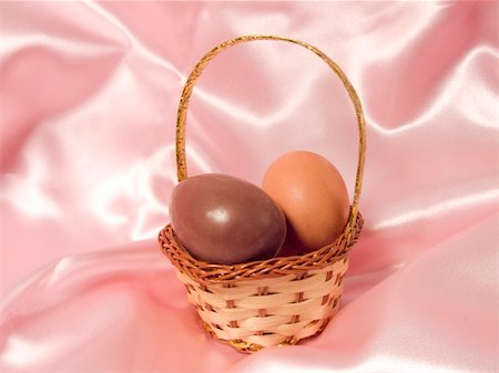 Eggs in a basket on a pink background to represent easter holidays Stock Photo - Budget Royalty-Free & Subscription, Code: 400-04432817