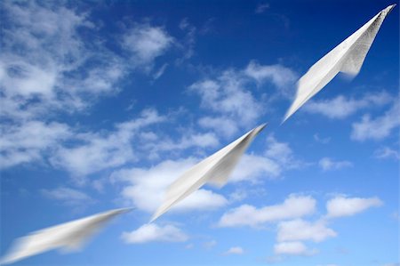 paper airplane blue sky - Paper aeroplane made of newspaper page in flight Stock Photo - Budget Royalty-Free & Subscription, Code: 400-04433236