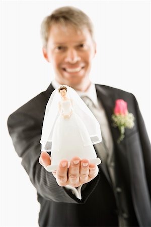 Caucasian groom holding out bride figurine in palm of his hand. Stock Photo - Budget Royalty-Free & Subscription, Code: 400-04445214