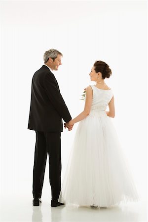 simsearch:400-04950359,k - Portrait of Caucasian groom and Asian bride holding hands. Stock Photo - Budget Royalty-Free & Subscription, Code: 400-04445219