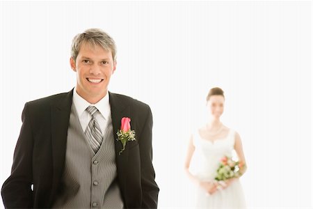 simsearch:400-04950359,k - Caucasian groom in foreground and Asian bride in background. Stock Photo - Budget Royalty-Free & Subscription, Code: 400-04445227