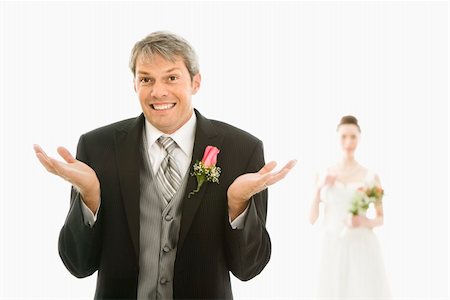 simsearch:400-04950359,k - Caucasian groom in foreground with hands raised in air and Asian bride in background. Stock Photo - Budget Royalty-Free & Subscription, Code: 400-04445228