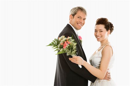 simsearch:400-04950359,k - Portrait of Caucasian groom and Asian bride embracing. Stock Photo - Budget Royalty-Free & Subscription, Code: 400-04445220