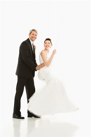 Portrait of Caucasian groom pushing Asian bride in swing. Stock Photo - Budget Royalty-Free & Subscription, Code: 400-04445235