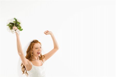 simsearch:400-04950359,k - Portrait of Caucasian bride holding bouquet and raising arms. Stock Photo - Budget Royalty-Free & Subscription, Code: 400-04445245