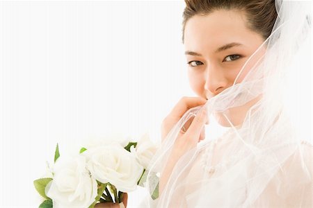 simsearch:400-04950359,k - Portrait of Asian bride with bouquet and pulling veil over face. Stock Photo - Budget Royalty-Free & Subscription, Code: 400-04445242