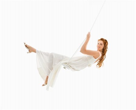 simsearch:400-04950359,k - Caucasian bride swinging in swing set and looking at viewer. Stock Photo - Budget Royalty-Free & Subscription, Code: 400-04445243