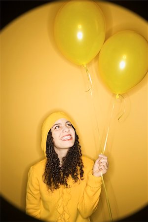 raincoat hood - Smiling young Caucasian woman with balloons wearing yellow raincoat on yellow background. Stock Photo - Budget Royalty-Free & Subscription, Code: 400-04445357
