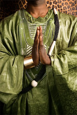 Close-up of African-American mid-adult man wearing traditional African clothing in prayer. Stock Photo - Budget Royalty-Free & Subscription, Code: 400-04445422