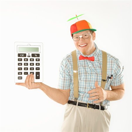 dunce cap - Caucasian young man dressed like nerd wearing beanie holding large calculator. Stock Photo - Budget Royalty-Free & Subscription, Code: 400-04445588