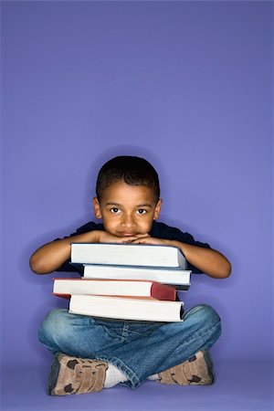 school boy sitting cross legged - African American male child sitting with books. Stock Photo - Budget Royalty-Free & Subscription, Code: 400-04445778