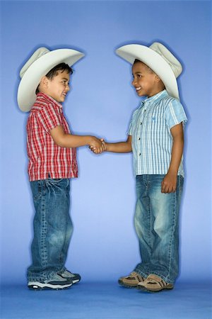 shaking hands kids - Hispanic and African American male child in cowboy hats shaking hands. Stock Photo - Budget Royalty-Free & Subscription, Code: 400-04445785