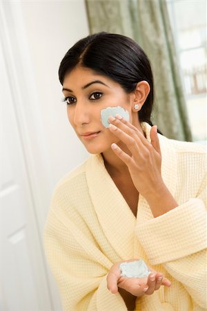 Close up of young Asian/Indian woman applying facial scrub. Stock Photo - Budget Royalty-Free & Subscription, Code: 400-04445915