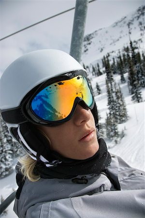 Caucasian teenage boy wearing helmet and goggles riding chair lift at ski resort. Stock Photo - Budget Royalty-Free & Subscription, Code: 400-04446147