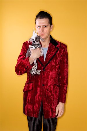 dog man bizarre - Caucasian mid-adult male wearing velvet holding Chinese Crested dog. Stock Photo - Budget Royalty-Free & Subscription, Code: 400-04446242