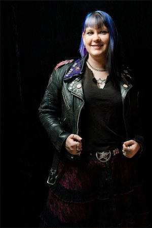 simsearch:400-03921001,k - Portrait of smiling Caucasian woman with blue hair and black leather jacket standing against black background. Stockbilder - Microstock & Abonnement, Bildnummer: 400-04446291