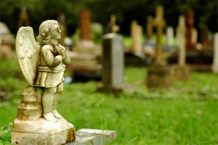 A very old little angel statue at cemetery Stock Photo - Budget Royalty-Free & Subscription, Code: 400-04446651