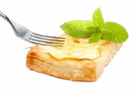 Fork and apple tart with leaves of mint on a dish. Soft shadow, isolated on white background. Shallow DOF Stock Photo - Budget Royalty-Free & Subscription, Code: 400-04446728