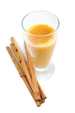 A vanilla milkshake and sticks of cinnamon reflected on white background Stock Photo - Budget Royalty-Free & Subscription, Code: 400-04446731