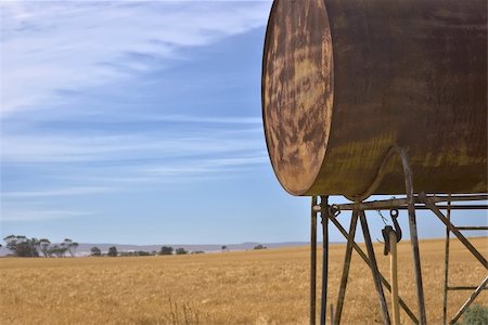 rusting tank - an old fuel tank and a field of wheat Stock Photo - Budget Royalty-Free & Subscription, Code: 400-04446796