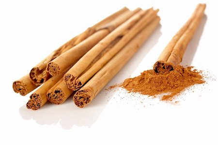 simsearch:400-04791848,k - Sticks and powder of cinnamon reflected on the white background. Shallow DOF Stock Photo - Budget Royalty-Free & Subscription, Code: 400-04447270