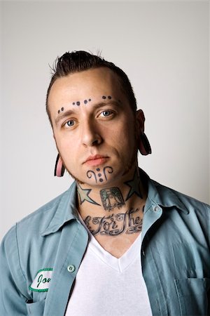 simsearch:400-03923064,k - Caucasian mid-adult man with tattoos and piercings. Stock Photo - Budget Royalty-Free & Subscription, Code: 400-04448230