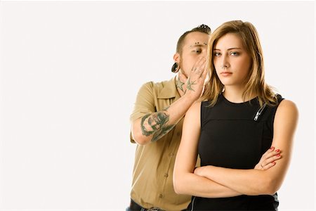 Caucasian mid-adult man whispering into ear of teen female. Stock Photo - Budget Royalty-Free & Subscription, Code: 400-04448247